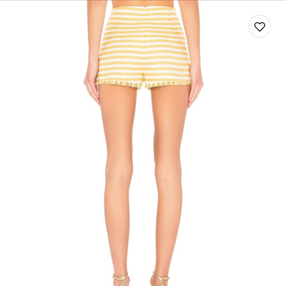 Yellow and white shorts with fringed hem